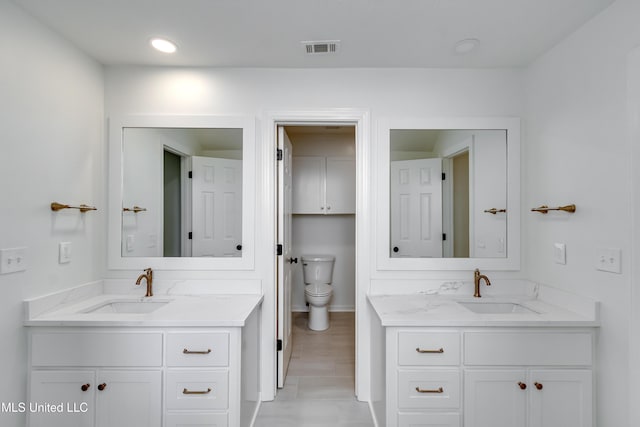 bathroom featuring toilet and vanity