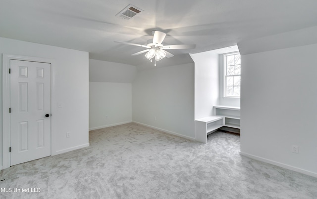 bonus room featuring light carpet, ceiling fan, and vaulted ceiling