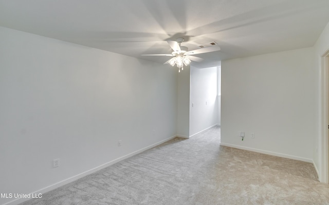 carpeted empty room featuring ceiling fan