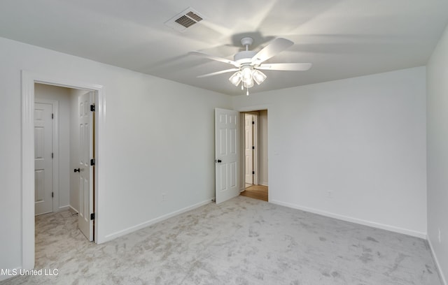 empty room featuring ceiling fan and light colored carpet