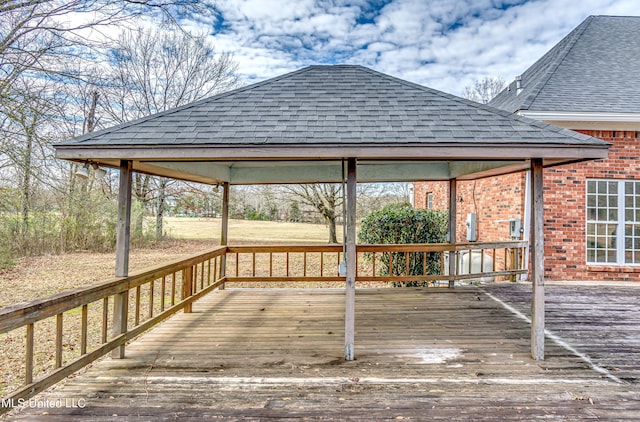 wooden terrace featuring a gazebo