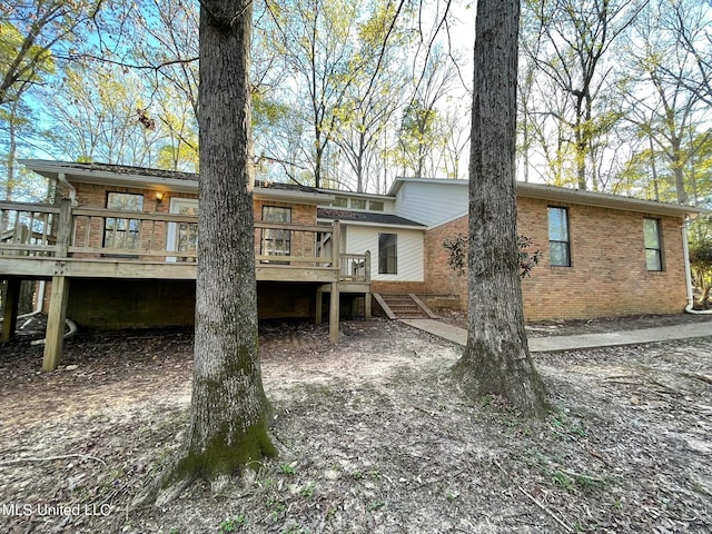 rear view of house featuring a deck