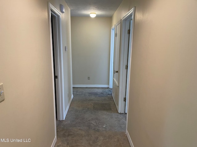 corridor with a textured ceiling