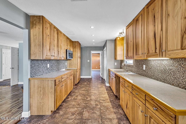 kitchen featuring tasteful backsplash and sink