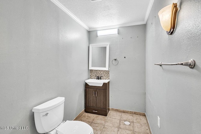 bathroom featuring crown molding, vanity, a textured ceiling, and toilet