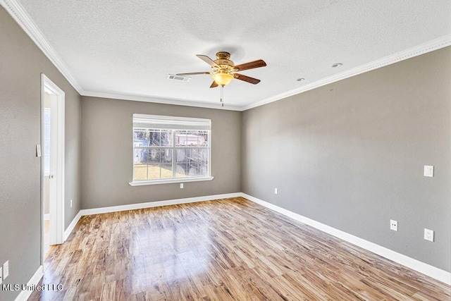 spare room featuring ceiling fan, light hardwood / wood-style flooring, ornamental molding, and a textured ceiling