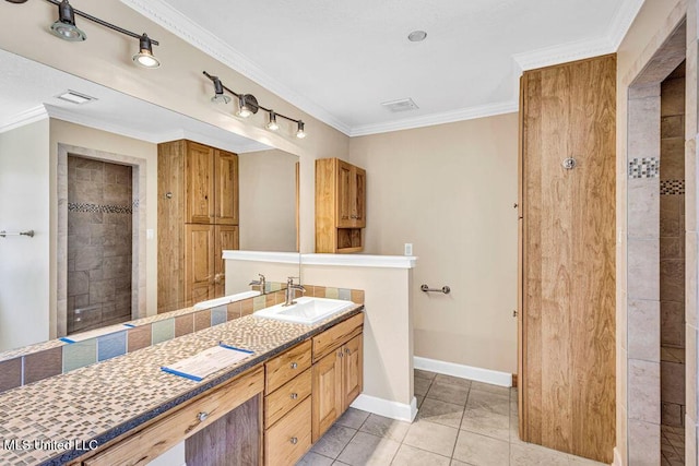 bathroom featuring crown molding, tile patterned floors, vanity, and a tile shower