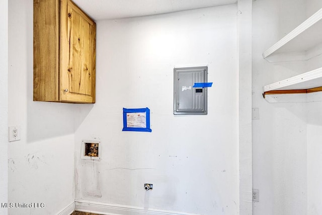 laundry area featuring washer hookup, electric panel, and cabinets