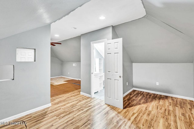 bonus room featuring vaulted ceiling, ceiling fan, and light hardwood / wood-style flooring