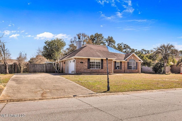 ranch-style house featuring a garage and a front yard