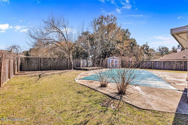 view of pool with a storage shed, a lawn, and a patio