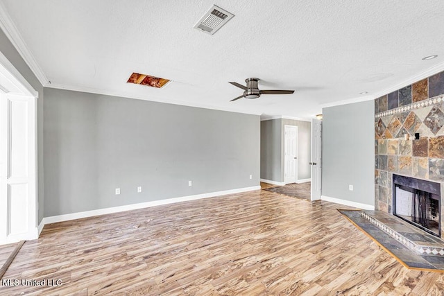 unfurnished living room with crown molding, a fireplace, light hardwood / wood-style floors, and ceiling fan