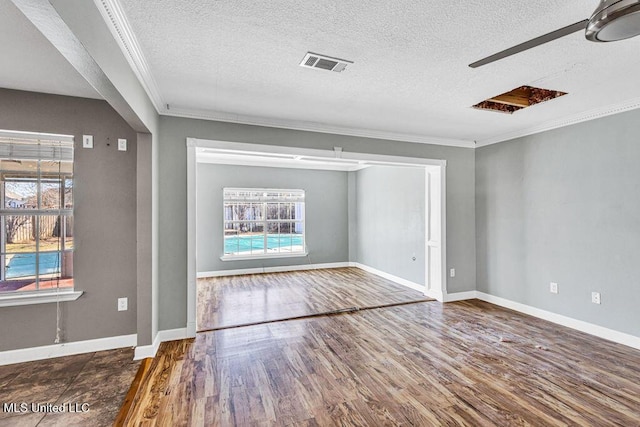 interior space featuring ornamental molding, dark hardwood / wood-style flooring, and a textured ceiling