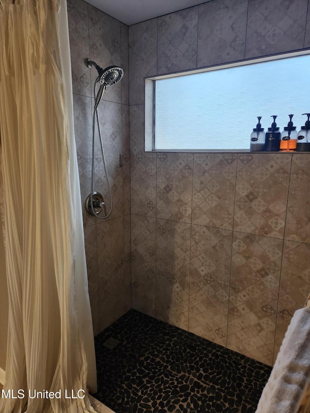 full bathroom with a tile shower