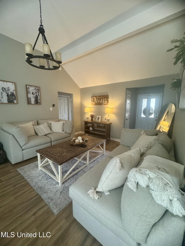 living room with baseboards, a notable chandelier, wood finished floors, and vaulted ceiling