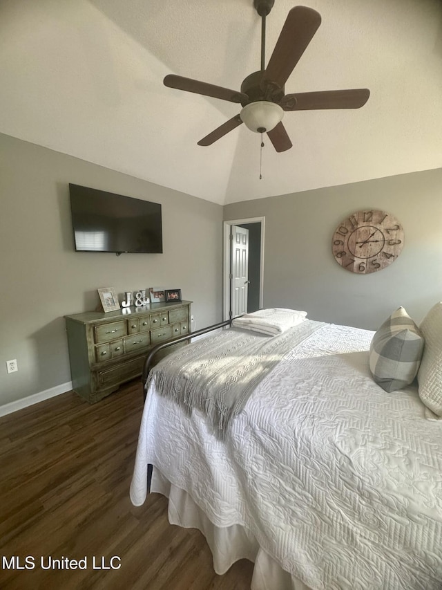 bedroom with ceiling fan, baseboards, vaulted ceiling, and wood finished floors