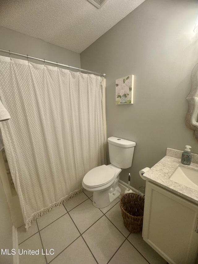 full bath with toilet, curtained shower, vanity, a textured ceiling, and tile patterned flooring