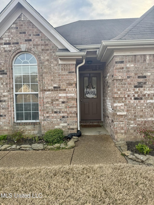 entrance to property with brick siding