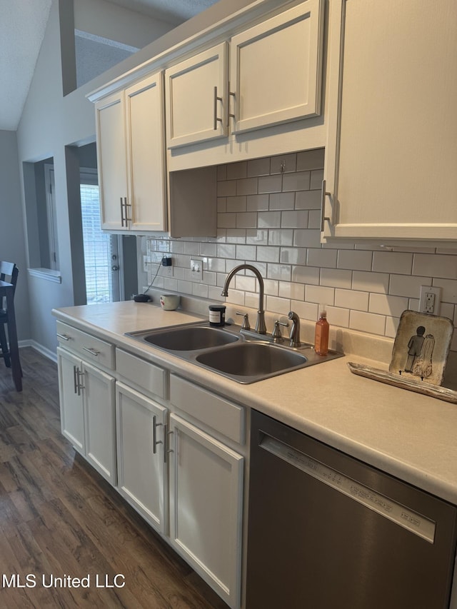 kitchen with vaulted ceiling, a sink, dishwasher, decorative backsplash, and dark wood-style flooring