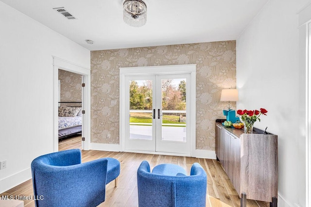 entryway with light hardwood / wood-style floors and french doors