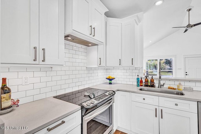 kitchen with sink, stainless steel electric range, premium range hood, white cabinetry, and vaulted ceiling