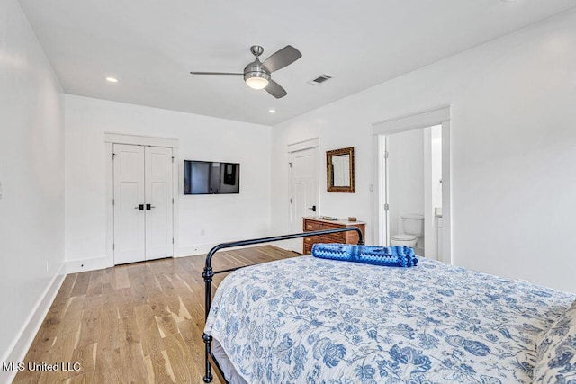 bedroom with ceiling fan, connected bathroom, and light wood-type flooring