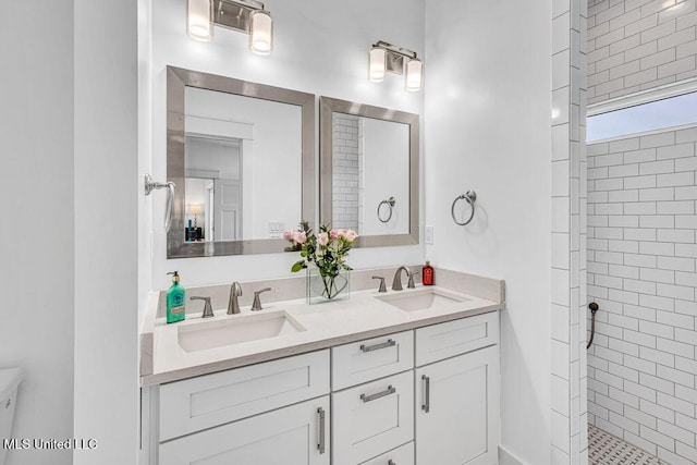 bathroom featuring vanity and a tile shower