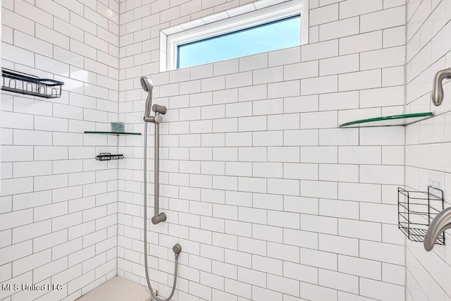 bathroom with tiled shower