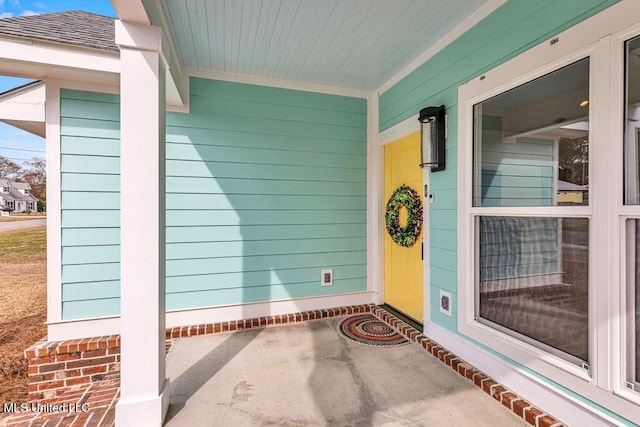 view of exterior entry with covered porch