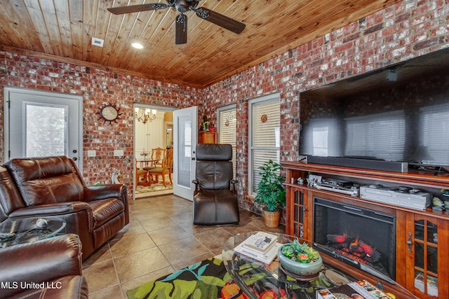 living room with light tile patterned flooring, ceiling fan with notable chandelier, wooden ceiling, and brick wall