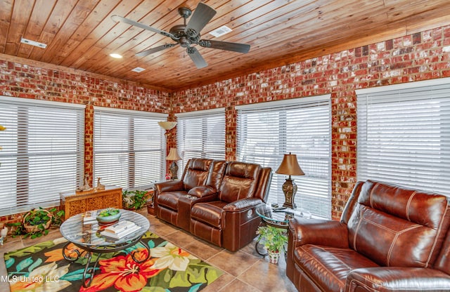 living room featuring ceiling fan, light tile patterned flooring, wood ceiling, and brick wall