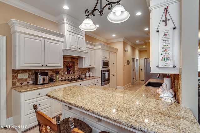 kitchen featuring backsplash, a kitchen breakfast bar, kitchen peninsula, decorative light fixtures, and white cabinetry