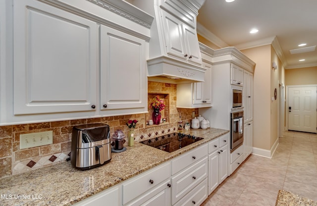 kitchen with light stone countertops, backsplash, stainless steel oven, crown molding, and white cabinets