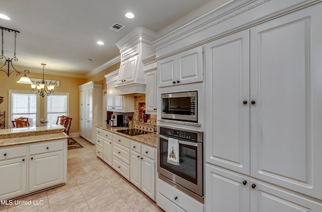 kitchen featuring pendant lighting, crown molding, appliances with stainless steel finishes, white cabinetry, and a chandelier