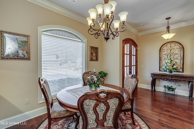 dining room featuring french doors, ornamental molding, dark wood-type flooring, and a chandelier