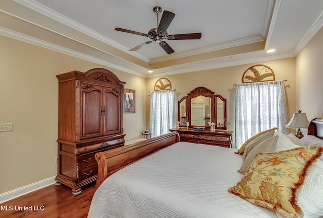 bedroom featuring ceiling fan, ornamental molding, dark wood-type flooring, and multiple windows