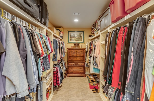 walk in closet featuring light tile patterned flooring