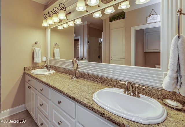 bathroom featuring tile patterned floors, vanity, and crown molding