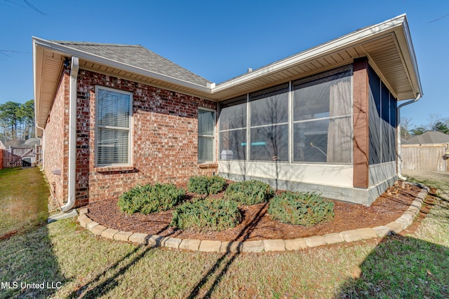 view of side of property with a yard