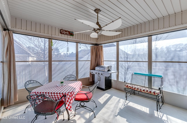 sunroom / solarium with a wealth of natural light and ceiling fan