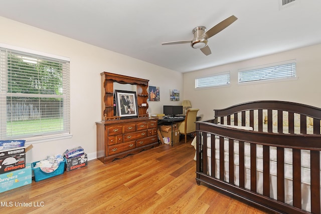 7829 Alawai Ave, Diamondhead, MS 39525 - bedroom with baseboards, a ceiling fan, and wood finished floors