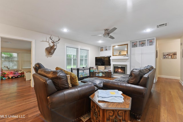 7829 Alawai Ave, Diamondhead, MS 39525 - living room featuring visible vents, ceiling fan, recessed lighting, wood finished floors, and a glass covered fireplace