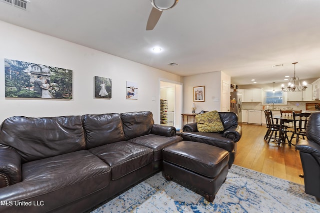 7829 Alawai Ave, Diamondhead, MS 39525 - living room with recessed lighting, light wood-type flooring, visible vents, and ceiling fan with notable chandelier