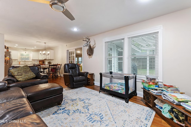 7829 Alawai Ave, Diamondhead, MS 39525 - living area featuring baseboards, recessed lighting, wood finished floors, and ceiling fan with notable chandelier