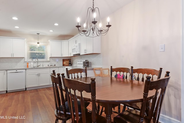 7829 Alawai Ave, Diamondhead, MS 39525 - dining space featuring recessed lighting, an inviting chandelier, and wood finished floors