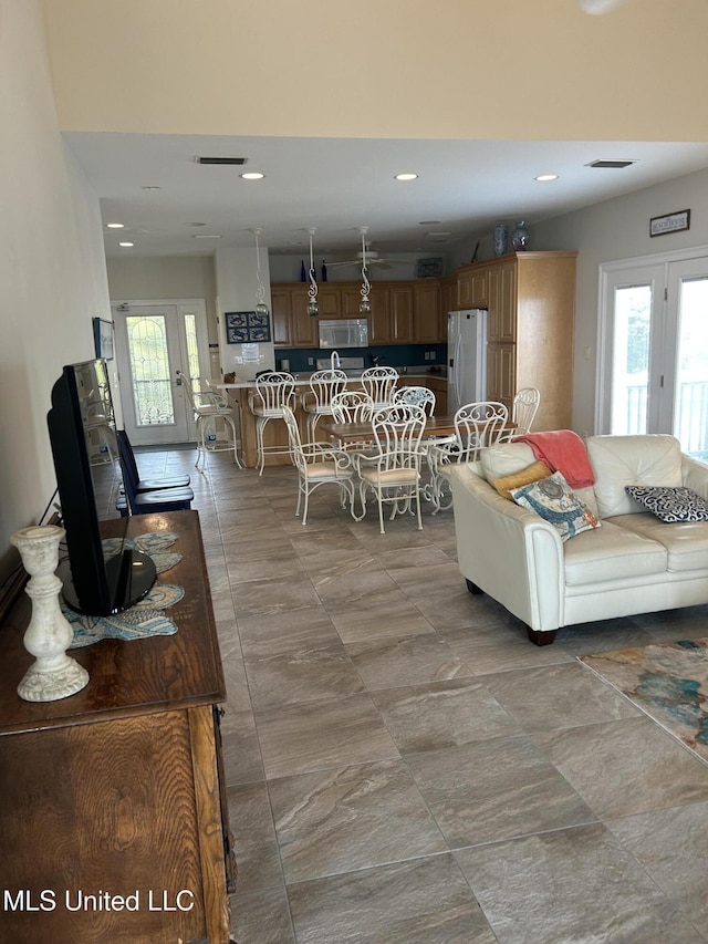 living area featuring plenty of natural light, visible vents, and recessed lighting