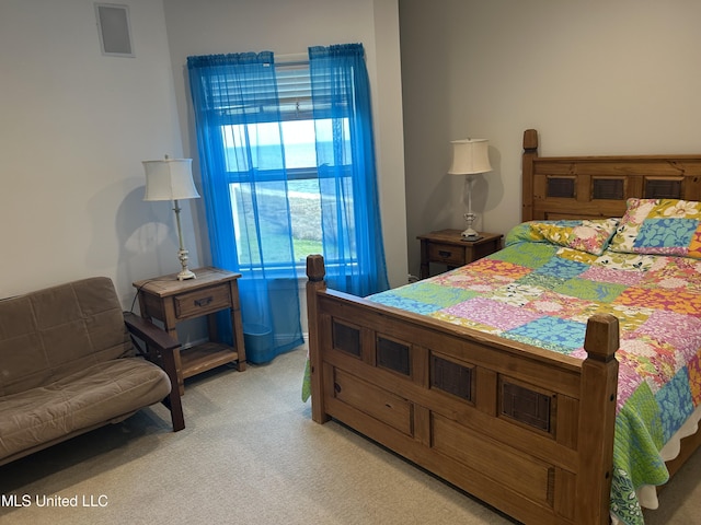 bedroom featuring light carpet and visible vents