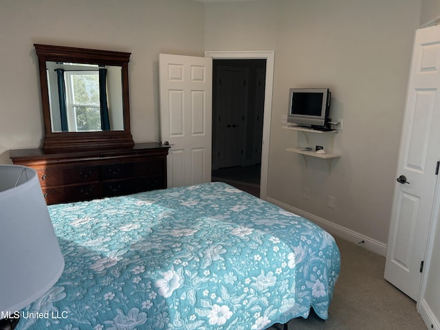 bedroom featuring carpet and baseboards