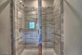 bathroom featuring a shower with door