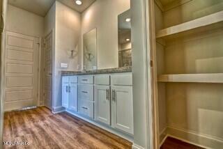 bathroom with hardwood / wood-style flooring